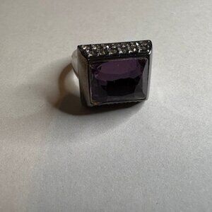 bold statement ring featuring a large, rectangular faceted purple gemstone